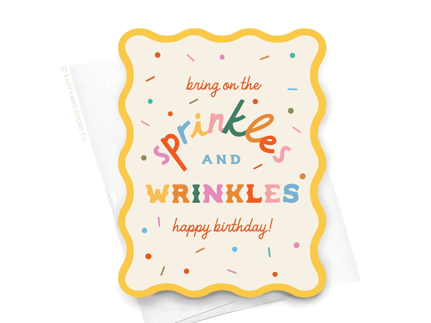 Greeting card with colorful text 'bring on the sprinkles and wrinkles happy birthday!' on a white background