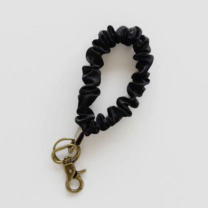 Black scrunchie keychain on a white background