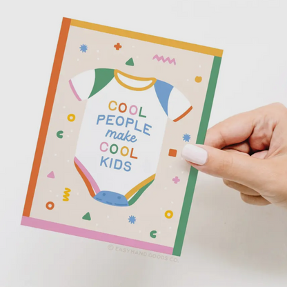 Hand holding a colorful card with text on a white background