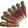 Decorative items resembling rocket ships with colorful designs on a white background