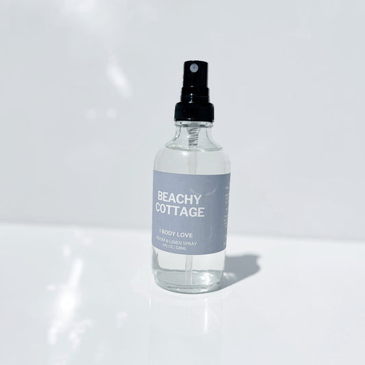 Clear spray bottle labeled 'Beachy Cottage' on a white background