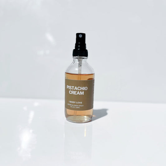 Clear spray bottle labeled 'Pistachio Cream' on a white surface