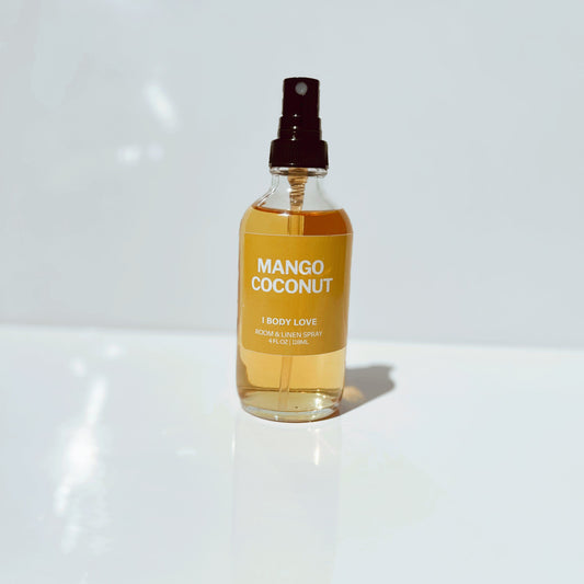 Mango Coconut body love spray bottle on a white surface
