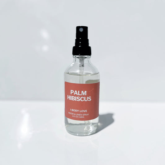 Clear spray bottle Palm Hibiscus label on a Red background