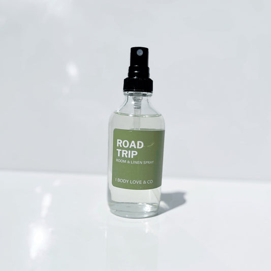 Clear spray bottle labeled 'Road Trip' on a white background