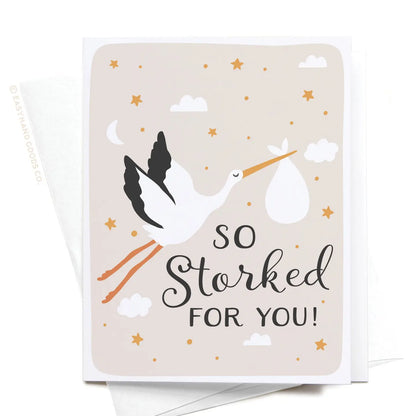 Greeting card with a stork illustration and text 'So Storked For You!' on a beige background.