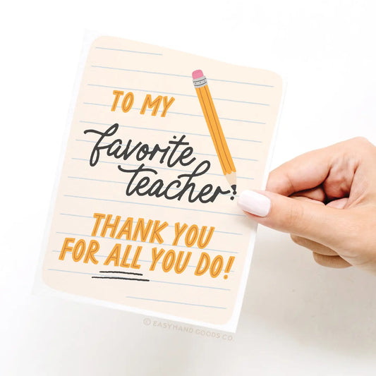 Notebook with 'To my favorite teacher, thank you for all you do!' text and a hand holding it.